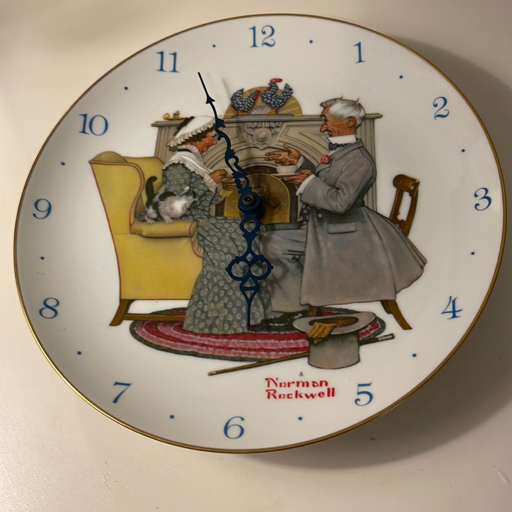 Vintage Norman Rocwell plate wall clock with gold rim.
